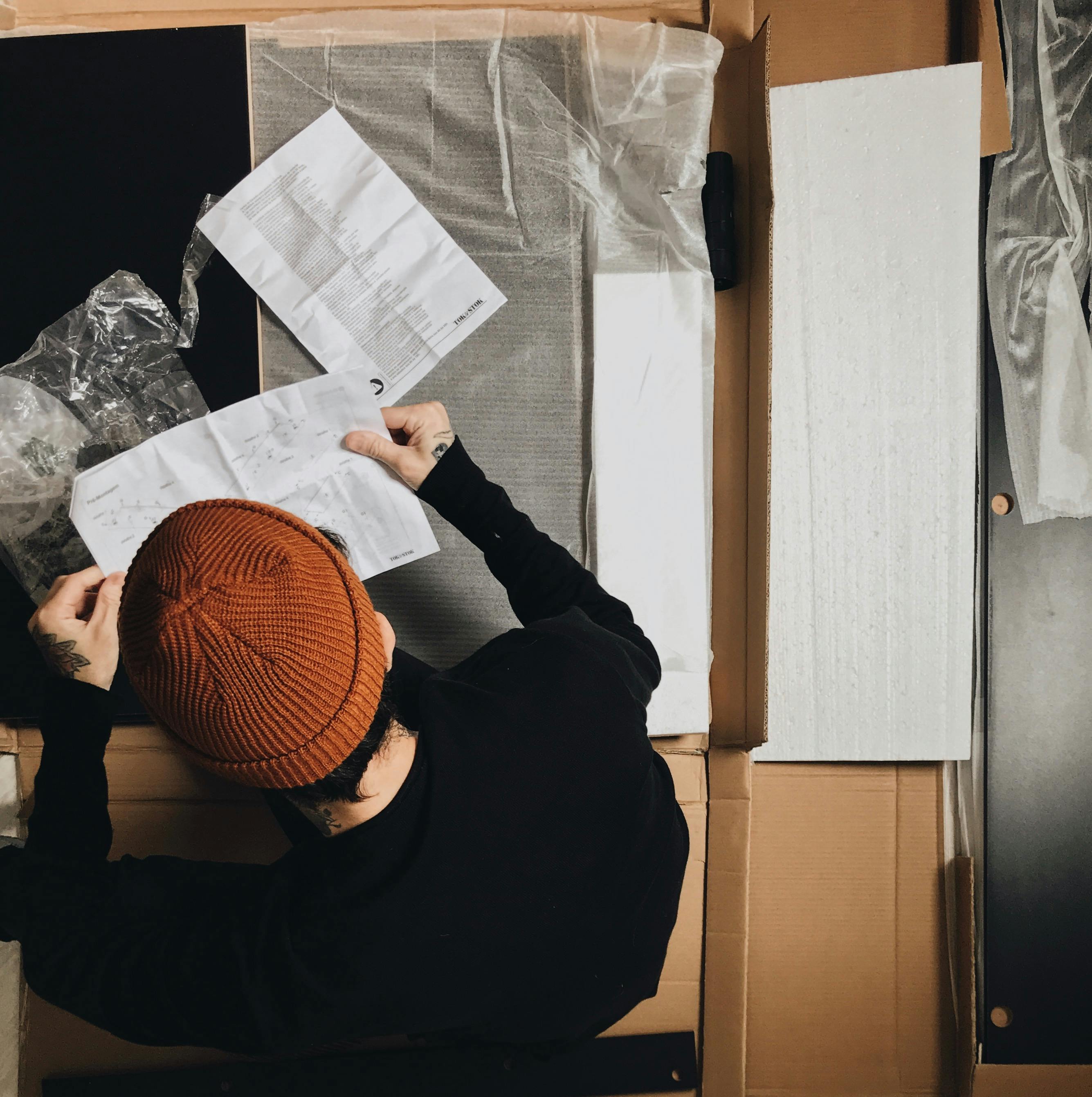 Arlington || funiture assembling || image of person reading instructions for furniture assembly
